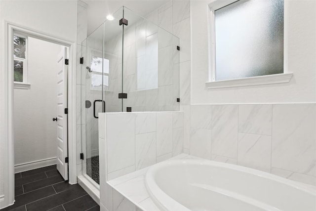 bathroom featuring plus walk in shower and tile patterned flooring