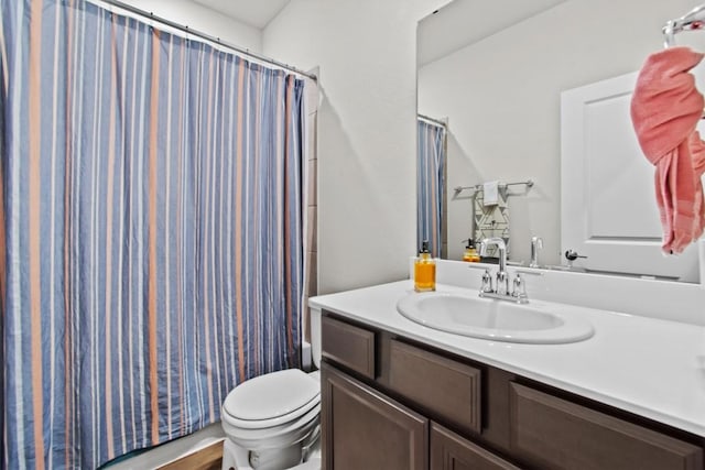 full bathroom featuring vanity, shower / bath combo with shower curtain, and toilet