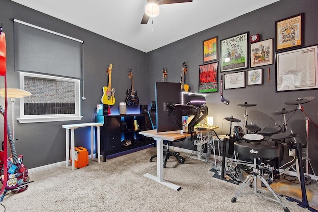 carpeted office space featuring ceiling fan