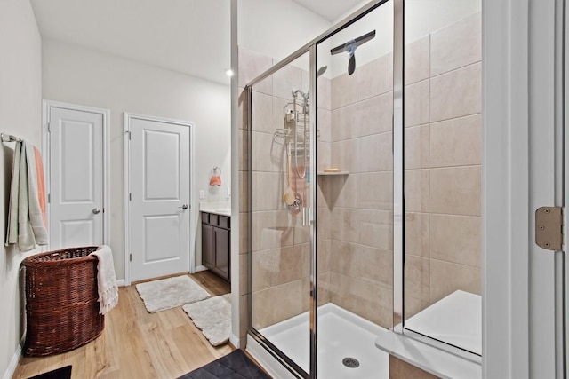 bathroom featuring vanity, an enclosed shower, and hardwood / wood-style floors