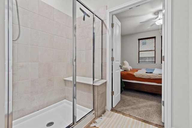 bathroom with ceiling fan and a shower with shower door