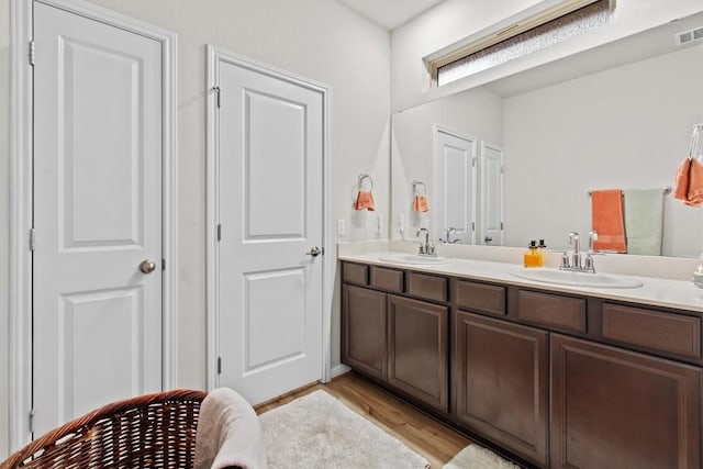 bathroom featuring vanity and hardwood / wood-style flooring