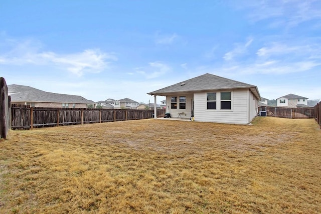 rear view of property with a yard