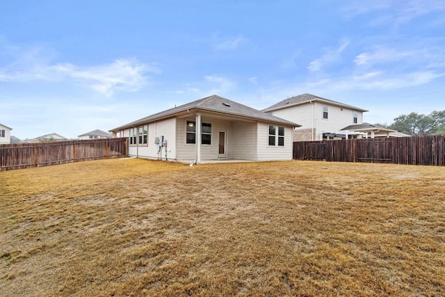 rear view of property with a yard