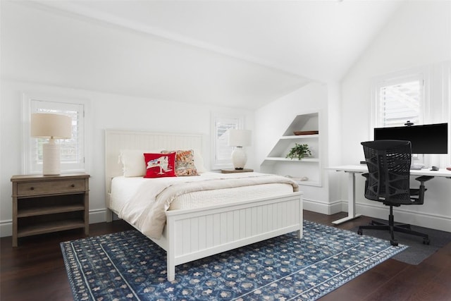 bedroom featuring dark wood-type flooring and vaulted ceiling