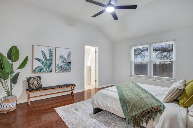 bedroom featuring lofted ceiling, connected bathroom, dark hardwood / wood-style floors, and ceiling fan