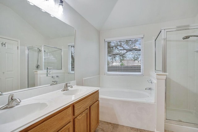 bathroom with tile patterned flooring, vanity, separate shower and tub, and vaulted ceiling