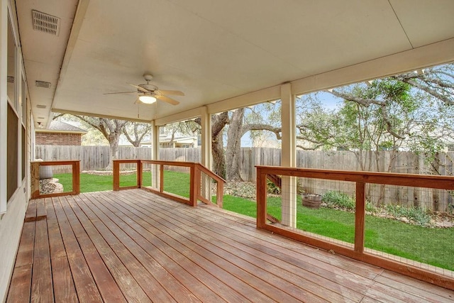 wooden deck featuring ceiling fan and a lawn