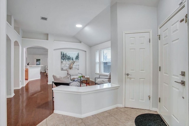 entrance foyer featuring lofted ceiling and light tile patterned flooring