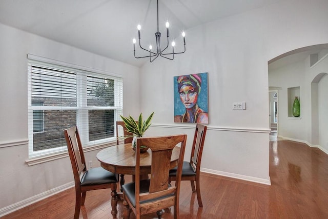 dining area with lofted ceiling and hardwood / wood-style floors