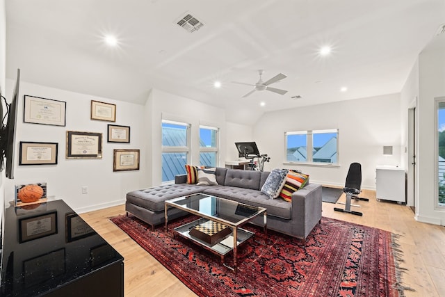 living room with ceiling fan and light hardwood / wood-style flooring