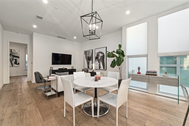 dining room featuring a chandelier and light hardwood / wood-style flooring