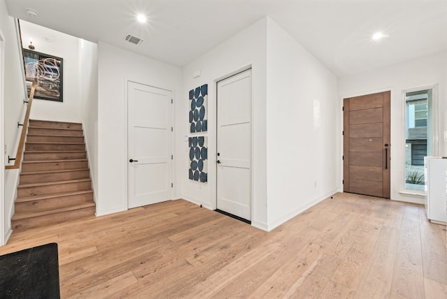 foyer entrance with light hardwood / wood-style floors