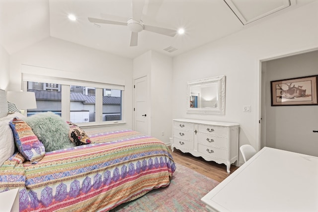 bedroom with vaulted ceiling, ceiling fan, and light hardwood / wood-style floors