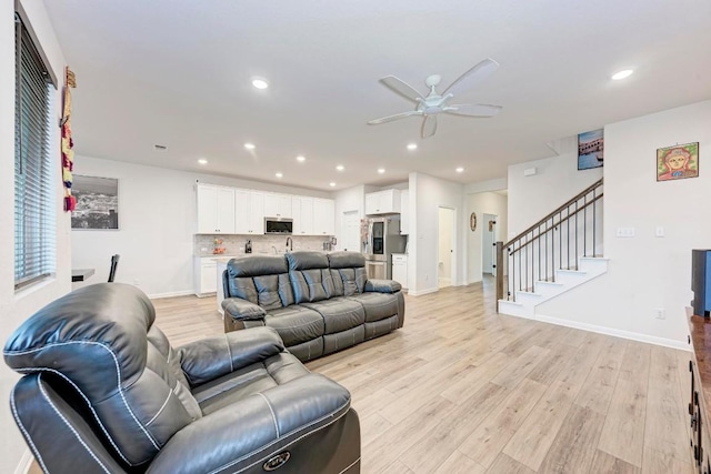 19312 Forman Dr, Pflugerville, TX 78660 - living room featuring a ceiling fan, light wood-style floors, stairs, recessed lighting, and baseboards
