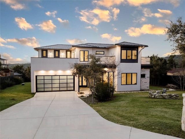 view of front of house with a garage and a lawn