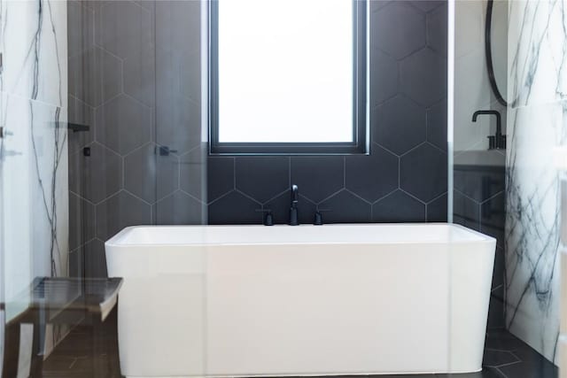 bathroom featuring tile patterned floors and tile walls