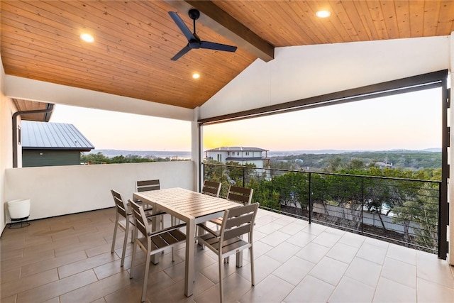 patio terrace at dusk featuring ceiling fan