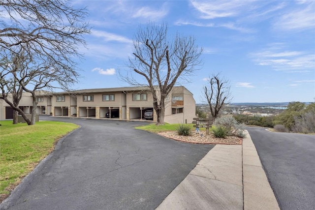 307 Poker Chip Unit 116, Horseshoe Bay, TX 78657 - view of property with a front lawn and stucco siding