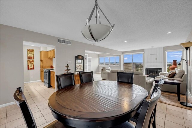 307 Poker Chip Unit 116, Horseshoe Bay, TX 78657 - dining area featuring light tile patterned floors, a fireplace, and recessed lighting