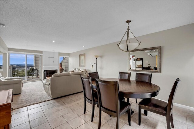 307 Poker Chip Unit 116, Horseshoe Bay, TX 78657 - dining area with light tile patterned flooring, a fireplace, and recessed lighting