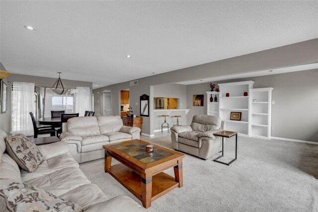 307 Poker Chip Unit 116, Horseshoe Bay, TX 78657 - living room featuring light colored carpet, a textured ceiling, and recessed lighting