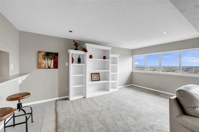 307 Poker Chip Unit 116, Horseshoe Bay, TX 78657 - sitting room featuring a textured ceiling, tile patterned flooring, recessed lighting, and carpet floors