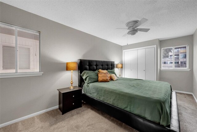 307 Poker Chip Unit 116, Horseshoe Bay, TX 78657 - carpeted bedroom with a closet, a textured ceiling, and a ceiling fan