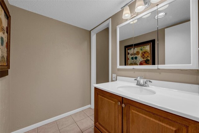 307 Poker Chip Unit 116, Horseshoe Bay, TX 78657 - bathroom featuring vanity, tile patterned flooring, and a textured ceiling