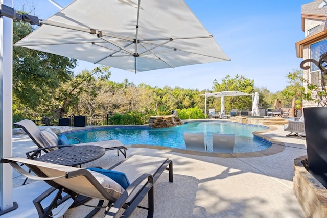 view of pool with a patio, fence, a jacuzzi, and a fenced in pool