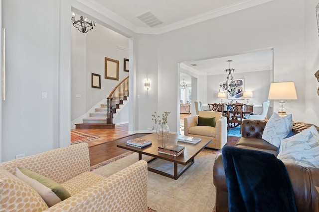 living room with light wood finished floors, visible vents, stairway, crown molding, and a chandelier