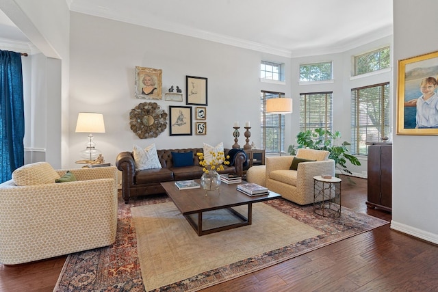 living room with dark wood-type flooring and crown molding