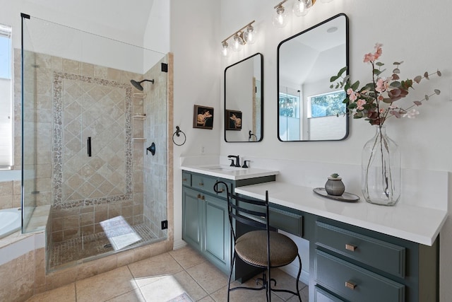 bathroom with vanity, lofted ceiling, shower with separate bathtub, and tile patterned floors