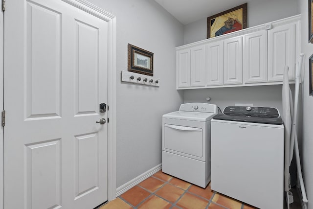 laundry room featuring light tile patterned floors, washer and clothes dryer, and cabinets