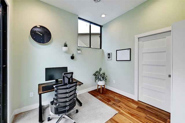 office with light hardwood / wood-style flooring