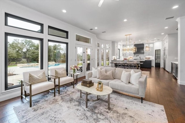 living room featuring ornamental molding, dark hardwood / wood-style floors, and french doors