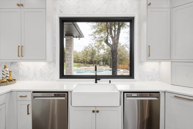 kitchen featuring white cabinetry, dishwasher, sink, and tasteful backsplash