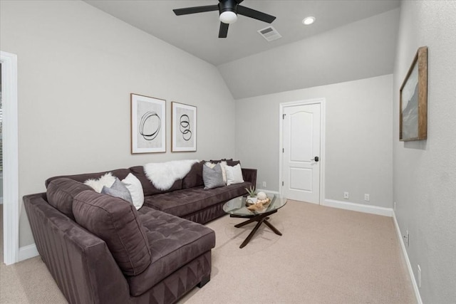 carpeted living room with ceiling fan and vaulted ceiling