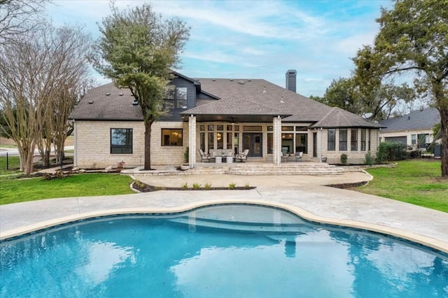 back of house featuring a yard and a patio area