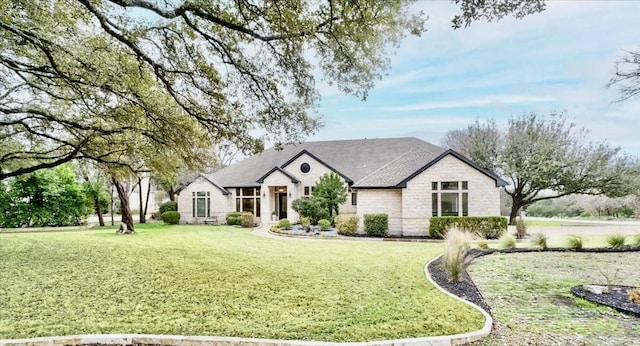 french country style house featuring a front lawn