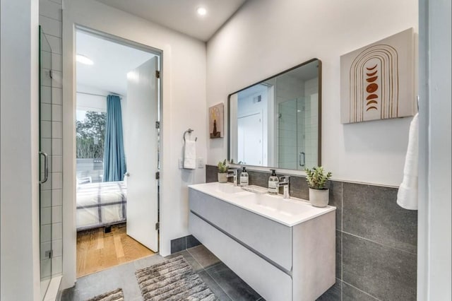 bathroom featuring vanity and tile walls