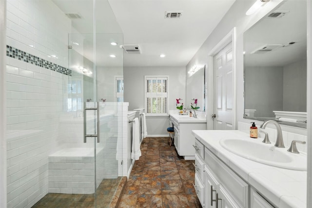 bathroom featuring vanity and a shower with door