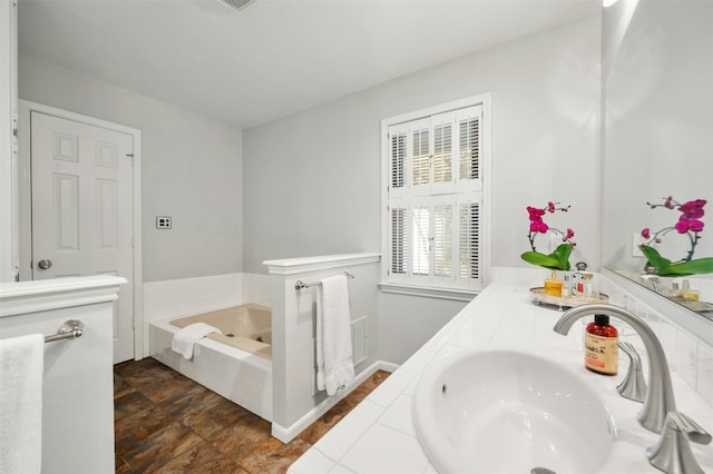 bathroom with vanity and a relaxing tiled tub