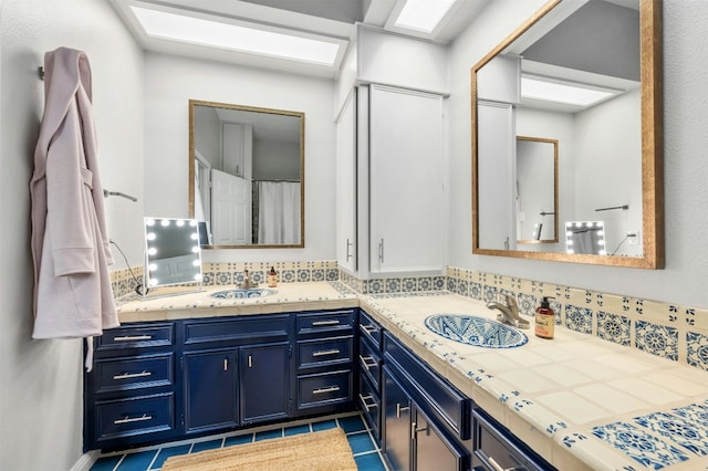 bathroom with tasteful backsplash, vanity, and tile patterned flooring