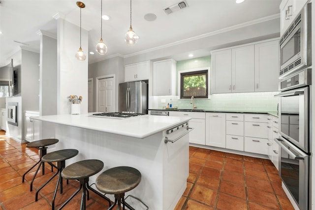 kitchen featuring a center island, stainless steel appliances, a breakfast bar, and white cabinets