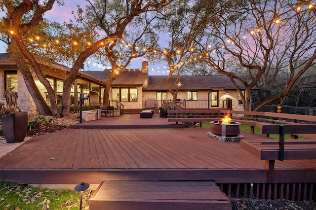 deck at dusk with an outdoor fire pit