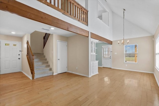 3959 Fm 535, Bastrop, TX 78602 - unfurnished living room with a chandelier, stairs, light wood finished floors, high vaulted ceiling, and recessed lighting