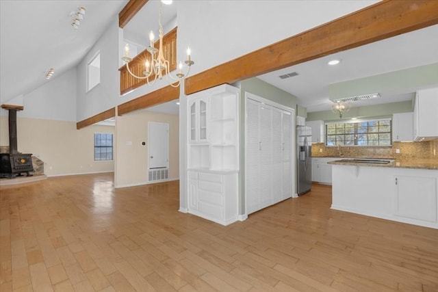 3959 Fm 535, Bastrop, TX 78602 - kitchen featuring stainless steel fridge, open floor plan, a chandelier, white cabinets, and backsplash