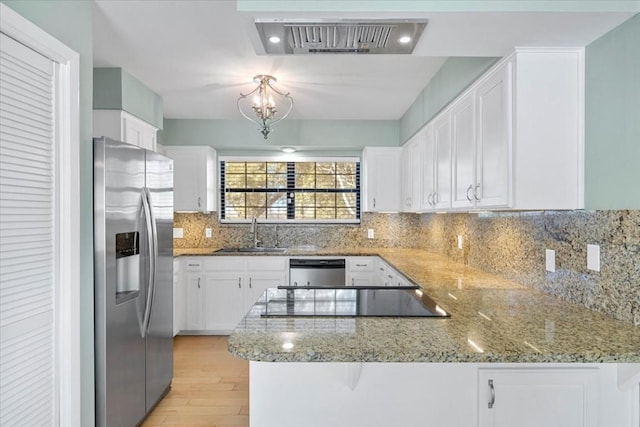 3959 Fm 535, Bastrop, TX 78602 - kitchen featuring stainless steel appliances, a peninsula, white cabinets, and light stone countertops