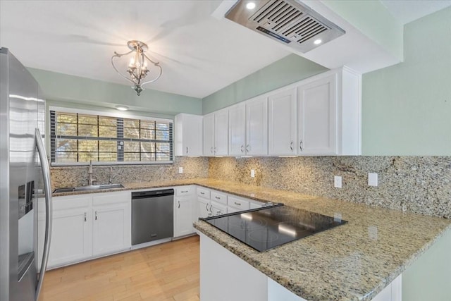 3959 Fm 535, Bastrop, TX 78602 - kitchen with stainless steel appliances, light wood-style floors, a peninsula, and white cabinets